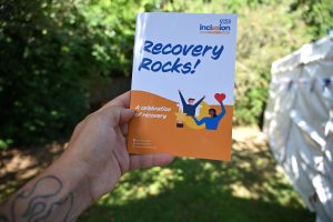 Hand holding Inclusion Isle of Wight Recovery Rocks booklet